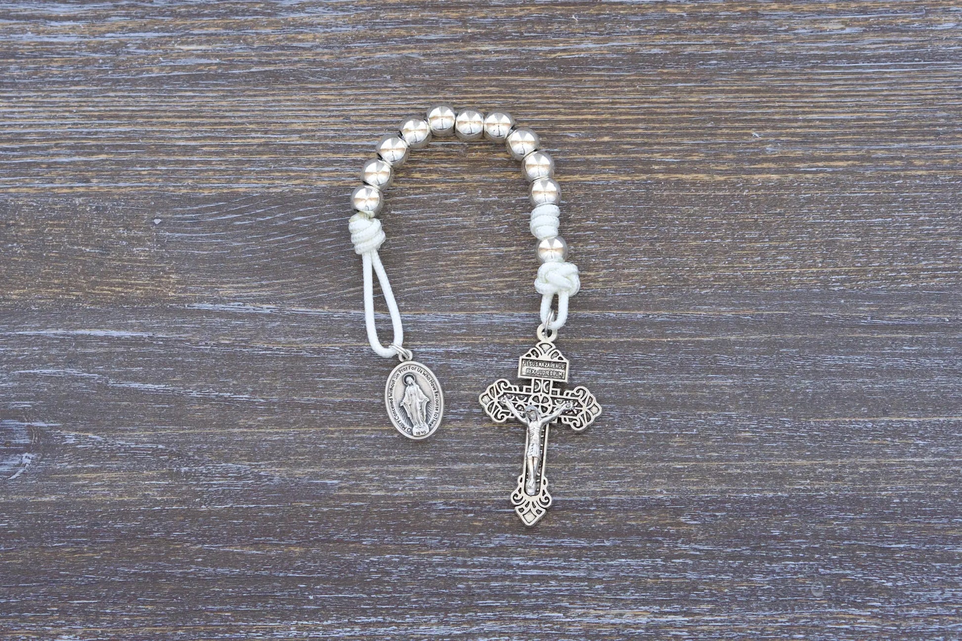 Divine Elegance premium metal paracord rosary with silver beads, crucifix, and medal in 4 vibrant colors.