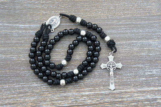 Premium metal alloy Hail Mary beads and silver Our Father beads on sturdy black paracord rosary, accented by a silver St. Benedict crucifix.