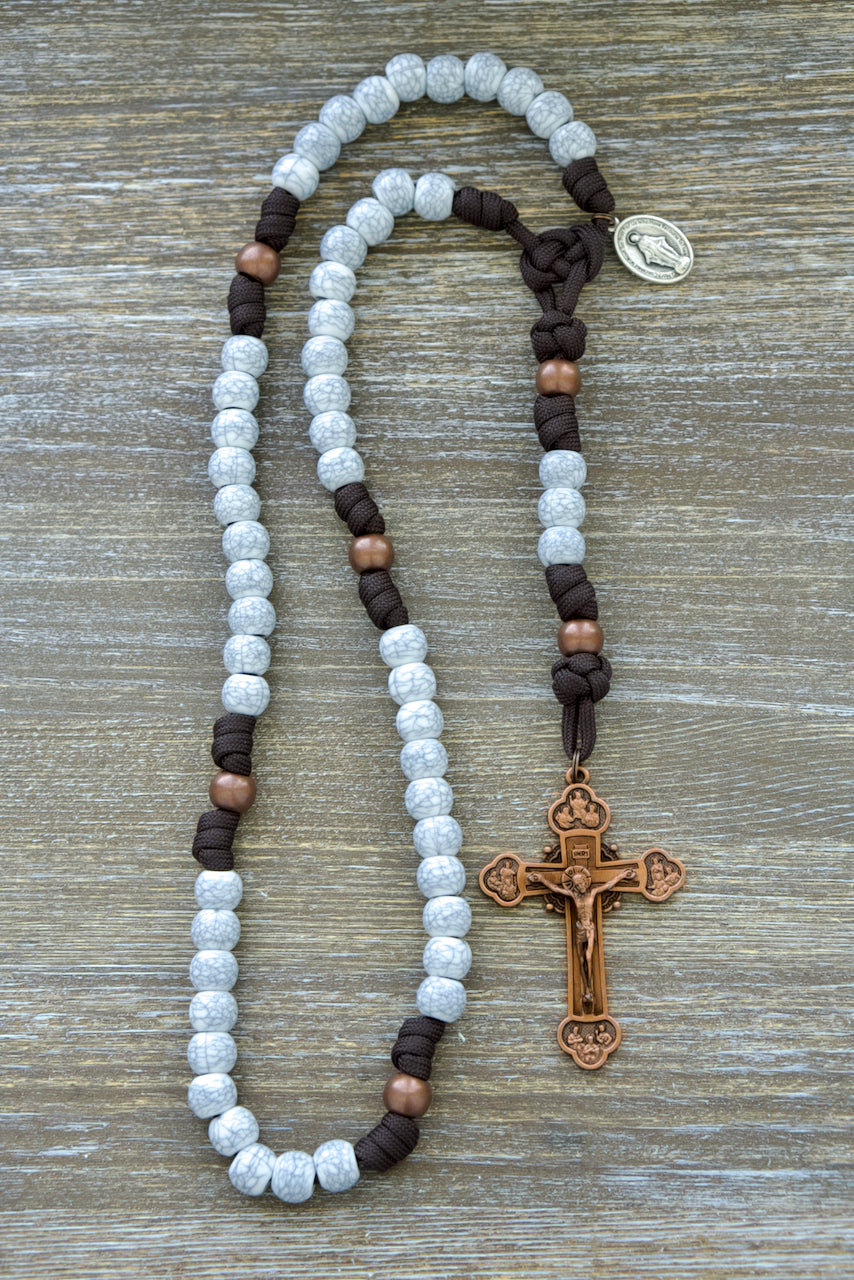 Embrace the Cross - 5 Decade Paracord Rosary featuring dark brown paracord, antique copper Our Father beads, cracked ivory Hail Mary beads, Miraculous Medal devotional medal, and a 3-inch copper 12-apostles Crucifix. Durable and powerful spiritual weapon for prayer by Sanctus Servo.