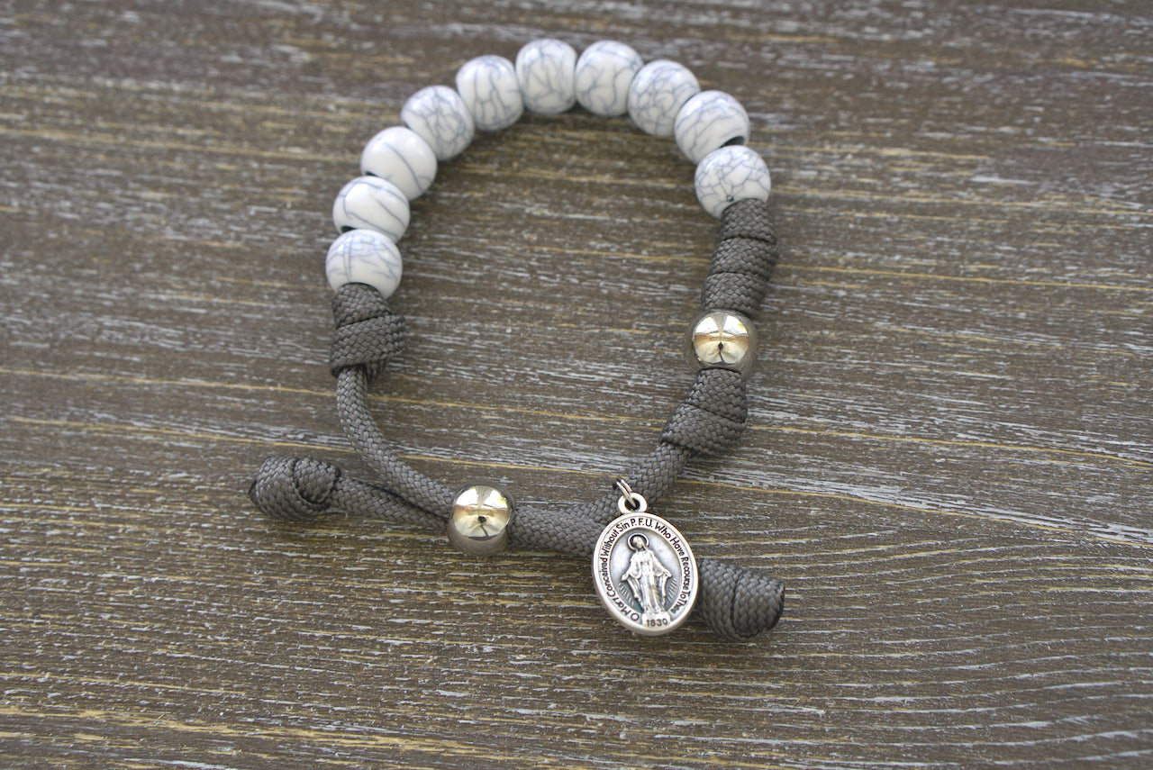 The Faithful Fortress Kids Rosary Bracelet - Handmade from Dark Grey Paracord, 10mm 'Cracked Ivory' Beads, Silver Our Father Bead and a Miraculous Medal.