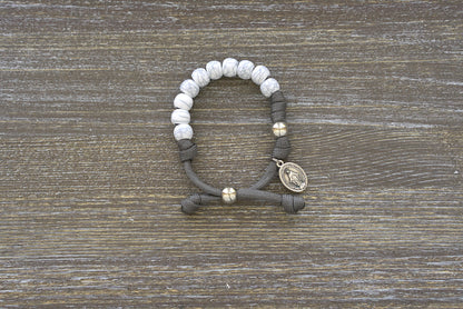 The Faithful Fortress Kid's Rosary Bracelet – Dark grey paracord rosary with small 'cracked ivory' beads, silver Our Father bead and a tiny Miraculous Medal.