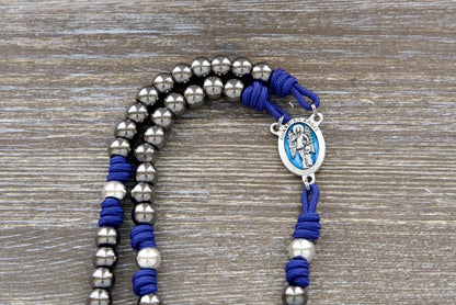 Royal blue, gunmetal, and silver Guardian Angel paracord rosary with durable paracord, premium alloy metal beads, and a striking blue enamel centerpiece - perfect for enhancing devotion to your Guardian Angel.