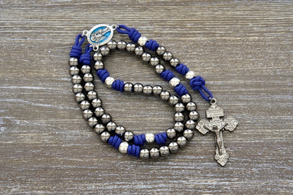 Premium Royal Blue Paracord Rosary with Gunmetal and Silver Beads, featuring a Blue Enamel Guardian Angel Centerpiece and a 2-inch Gunmetal Pendant Crucifix. The perfect Catholic gift for enhancing devotion to your Holy Guardian Angel.