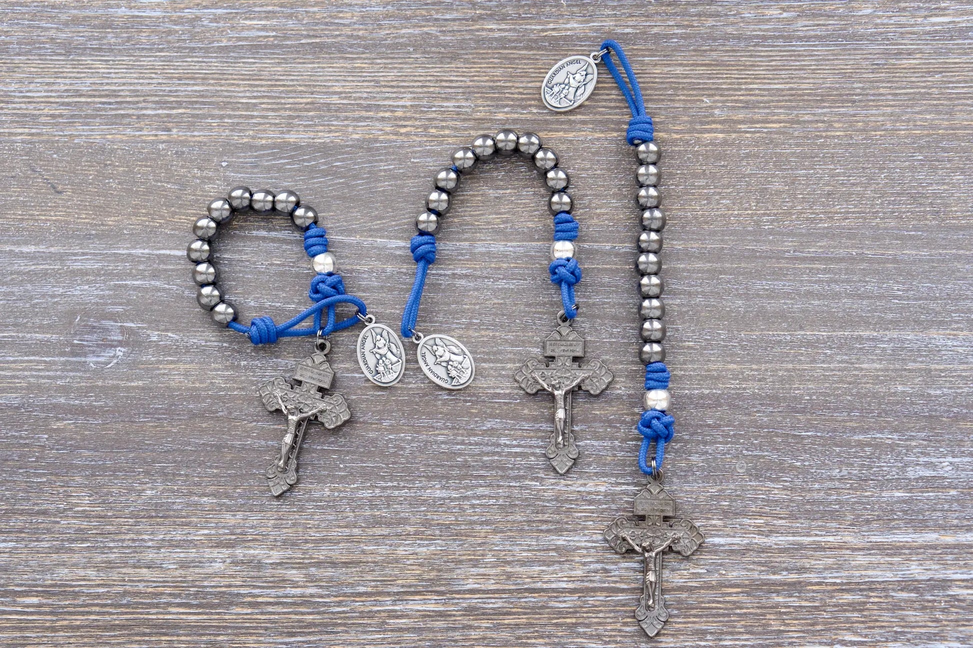 Premium metal beaded pocket paracord rosary featuring blue rope, gunmetal pardon crucifix, gunmetal and silver metal alloy beads.