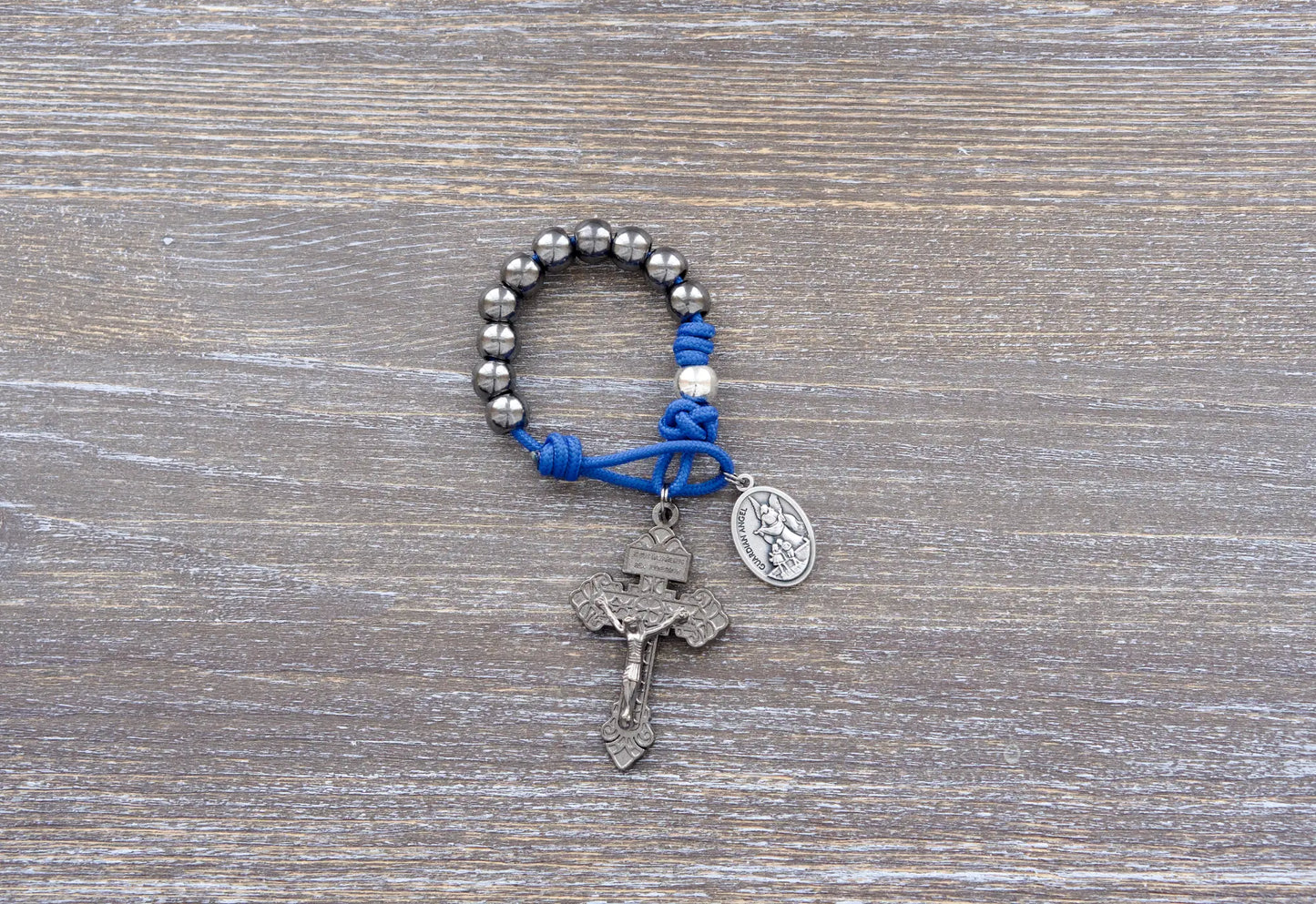 Guardian of Grace pocket paracord rosary with blue rope, gunmetal crucifix, and silver and gunmetal alloy beads.