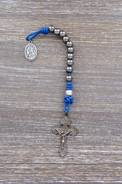 Guardian of Grace paracord rosary with blue rope, gunmetal crucifix, and silver alloy beads.