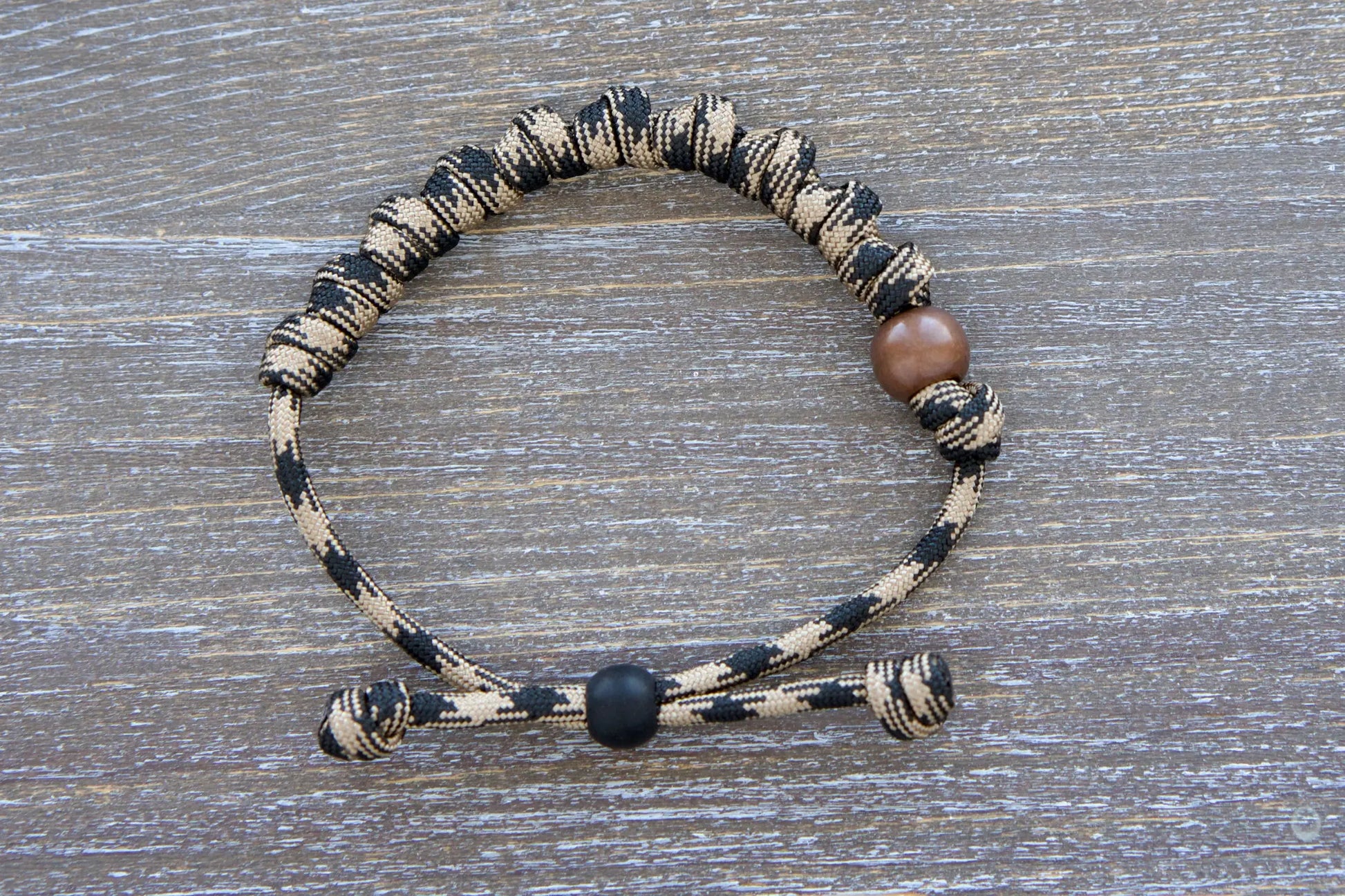 Heavy Duty Hail Mary rosary bracelet: black/brown camo paracord, 12mm and 10mm acrylic beads, adjustable, rugged and devout.