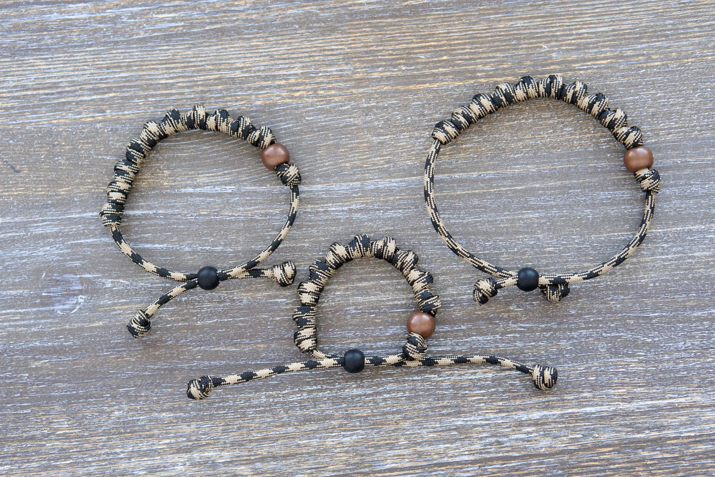 Heavy Duty Hail Mary rosary bracelet: black/brown camo paracord, 12mm and 10mm acrylic beads, 10 knots for 10 Hail Mary prayers.