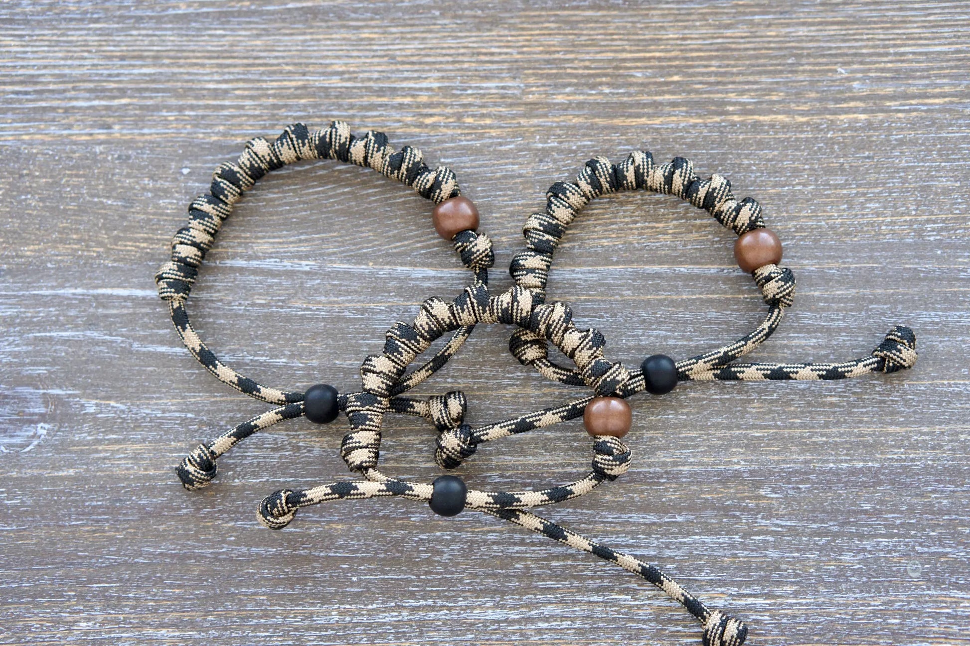 Hail Mary rosary bracelet with black/brown camo paracord and bold beads—each knot holds a Hail Mary prayer!
