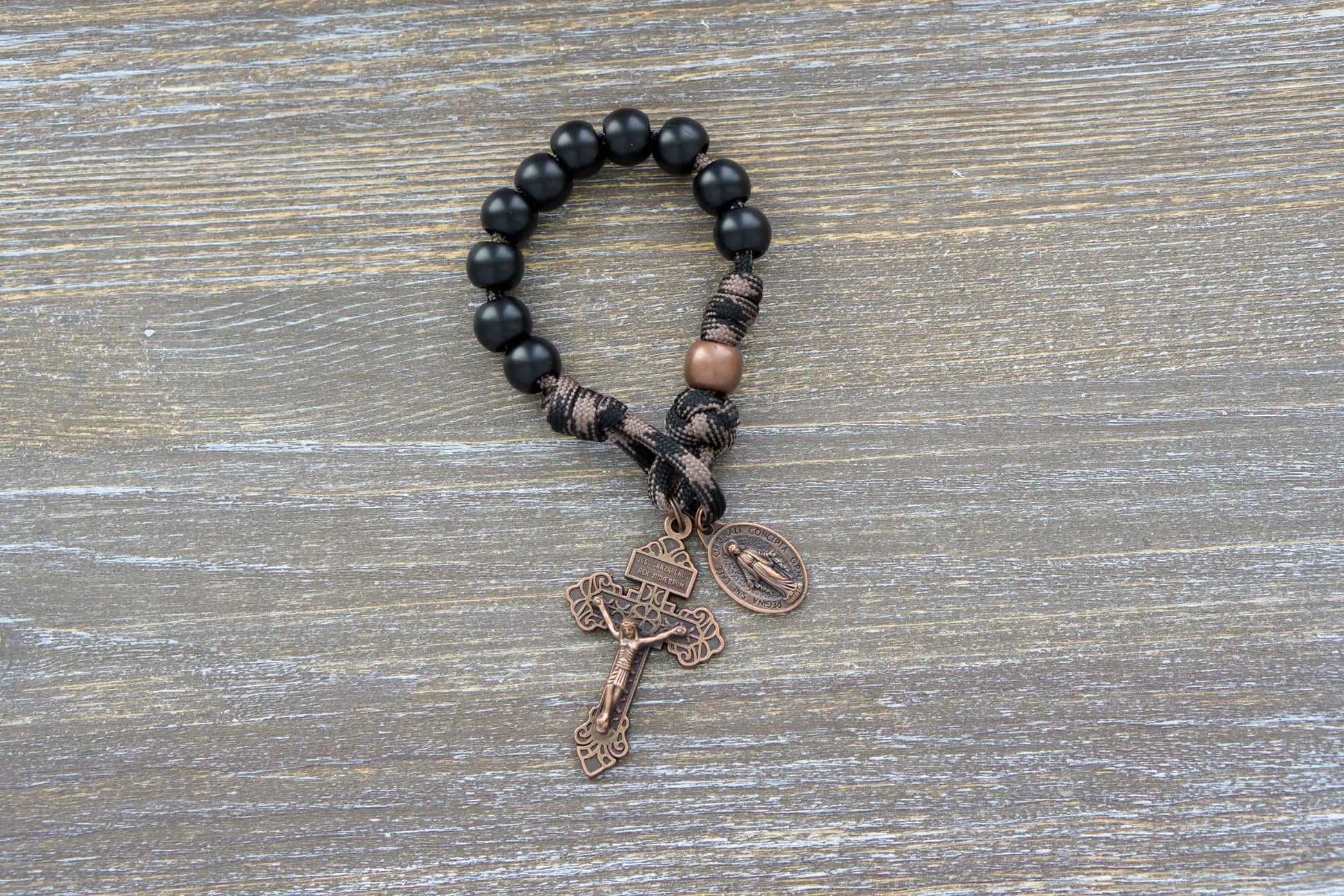 Heavy Duty Hail Mary Pocket Rosary: black acrylic Hail Mary beads, antique copper Our Father bead, crucifix, and Miraculous Medal on durable paracord cord.