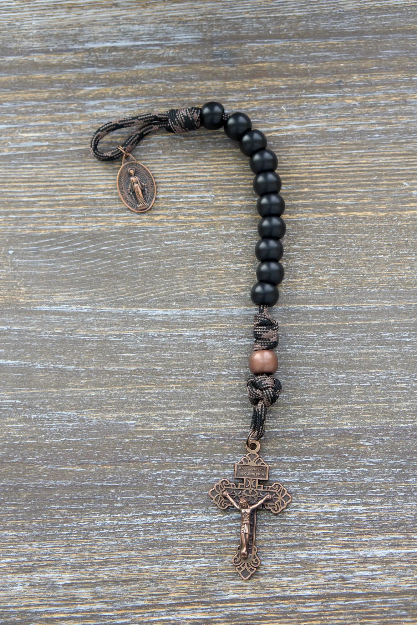 Heavy Duty Hail Mary Pocket Rosary: black acrylic beads, antique copper Our Father bead, crucifix, and Miraculous Medal on paracord cord.