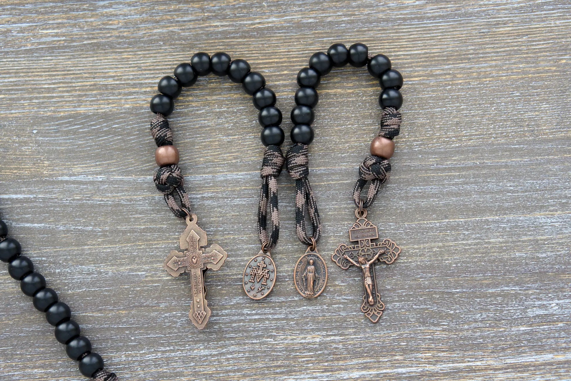 Heavy Duty Hail Mary Pocket Rosary: Matte black acrylic Hail Mary beads, antique copper Our Father bead, crucifix, and Miraculous medal on durable paracord cord.