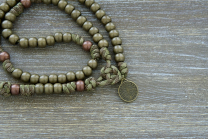 Holy Defense - 5 Decade Paracord Rosary, a durable and premium camo paracord rosary designed for adults seeking a unique military-inspired devotion. Featuring an olive St. Benedict medal and a striking white and olive enamel St. Benedict crucifix.