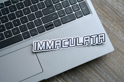 Immaculata Vinyl Sticker -  A white semi-glossy sticker (7.17" x 1.14") featuring the Militia of the Immaculata emblem, honoring St. Maximilian Kolbe's mission against heresy and modernism. Matte laminated for durability and UV resistance, suitable for indoor/outdoor use on various surfaces.