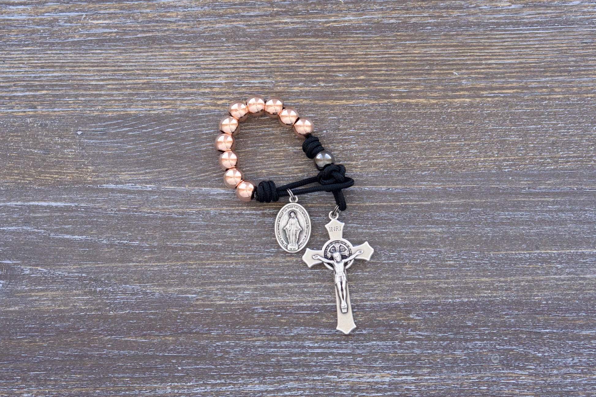 Immaculate Strength premium metal paracord rosary with black cord and rose gold beads, sleek and durable design.