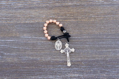 Immaculate Strength premium metal paracord rosary with black cord and rose gold beads, sleek and durable design.