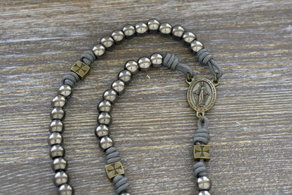 Iron Crusader Rosary: Handmade paracord rosary featuring olive metal Our Father beads, gunmetal Hail Mary beads, a Miraculous Medal centerpiece, and a triple threat Pardon crucifix.