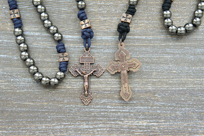 Black or navy blue paracord rosary featuring gunmetal Hail Mary beads, copper accents including a St. Michael centerpiece medal, and a Crucifix.