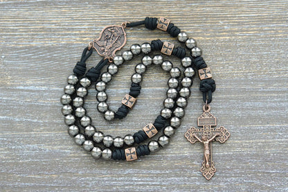 Gunmetal metal alloy Hail Mary beads on midnight black paracord with a St. Michael centerpiece and crucifix adorn this rugged rosary. 