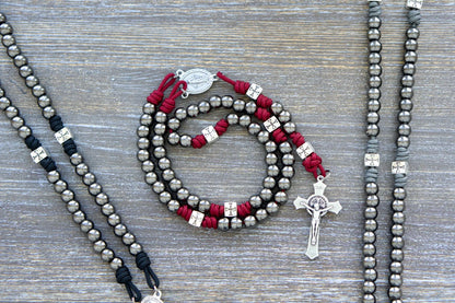 Last Stand Rosary: Gunmetal Hail Mary beads, silver crucifix, Miraculous Medal centerpiece, paracord in iron gray, black, and crimson red.