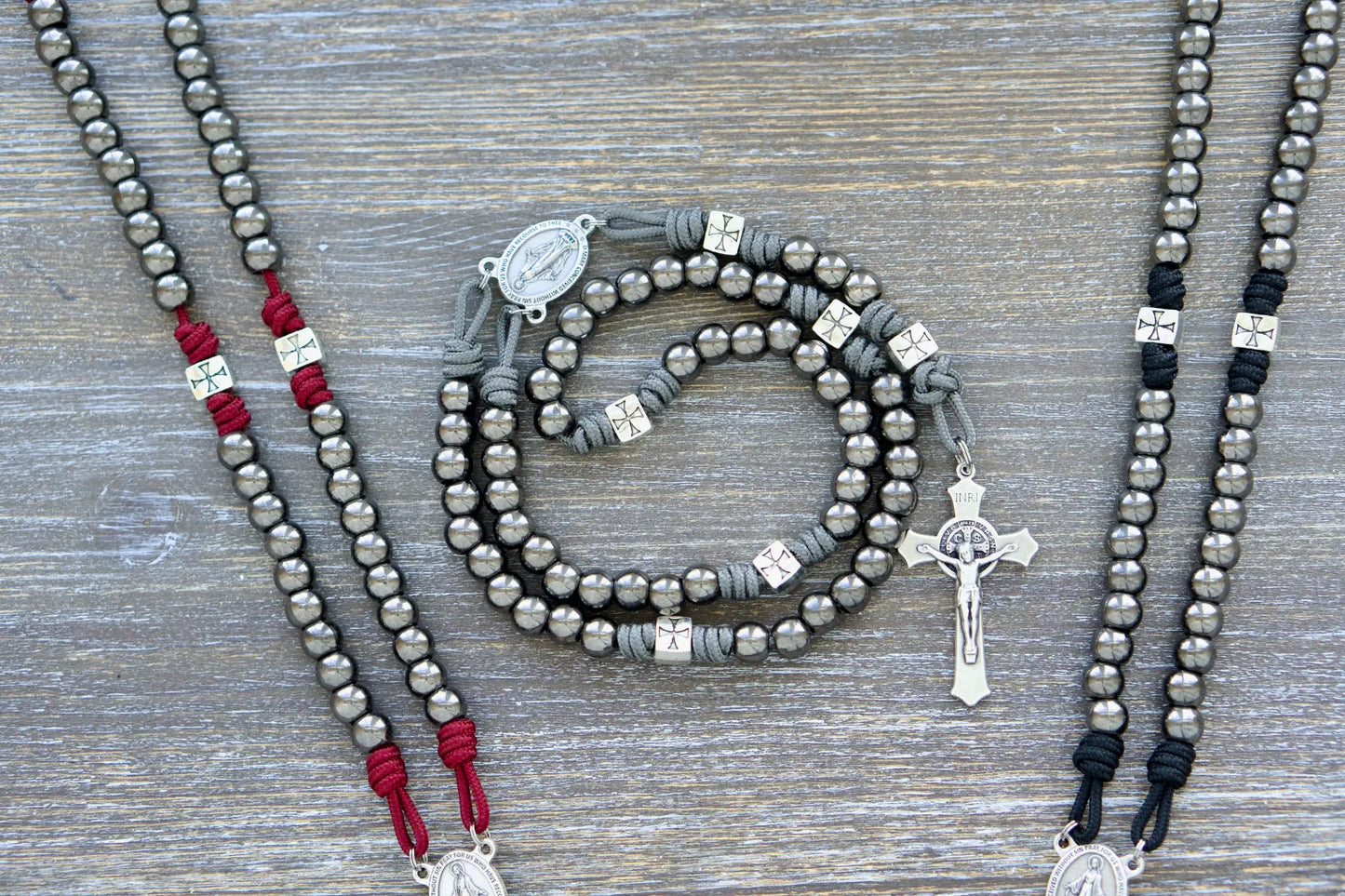 Last Stand Rosary: Gunmetal Hail Mary beads, silver Crusader Our Father beads, crimson, black, and gray paracord, Miraculous Medal centerpiece, and 2-inch St. Benedict crucifix.
