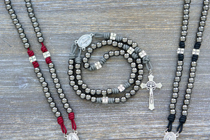 Last Stand Rosary: Gunmetal Hail Mary beads, silver Crusader Our Father beads, crimson, black, and gray paracord, Miraculous Medal centerpiece, and 2-inch St. Benedict crucifix.