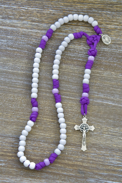 New 'Little Flowers of Jesus' five decade paracord rosary for kids, featuring high-quality purple paracord, light purple Our Father beads, white Hail Mary beads, St. Benedict crucifix, and Miraculous Medal - perfect Catholic gift for young hearts.