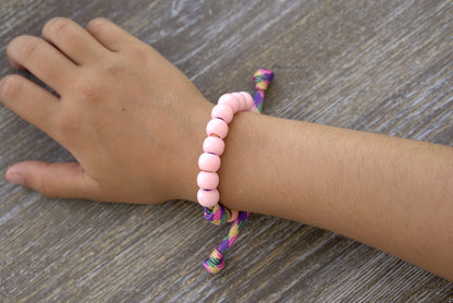 Little Lady's Miracle - Kid's Rosary Bracelet: Nurture young Catholic souls with this unique pink/green/orange paracord rosary bracelet featuring petite 10mm pink beads and matching orange Our Father beads. 