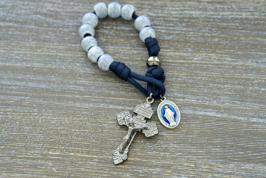 Marian Stronghold - Pocket Paracord Rosary: Premium quality, durable paracord rosary with navy blue rope, gunmetal Our Father beads, unique cracked ivory Hail Mary beads, 12mm acrylic beads, and a matching 2-inch pardon crucifix. Ideal Catholic gift for protection and guidance from Mary.