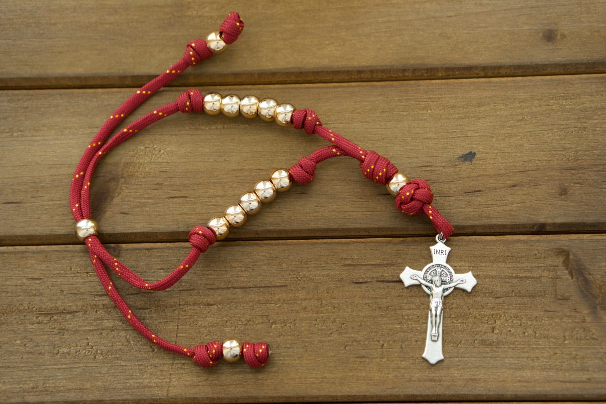 A durable, premium unbreakable paracord rosary perfect for Catholic travelers. Featuring a stunning maroon and rose gold design with a classic 2" St. Benedict Crucifix, this versatile rosary fits easily around car or truck rearview mirrors, ensuring spiritual protection on the go! Shop now at Sanctus Servo for more powerful Catholic gifts.