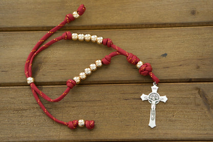 A durable, premium unbreakable paracord rosary perfect for Catholic travelers. Featuring a stunning maroon and rose gold design with a classic 2" St. Benedict Crucifix, this versatile rosary fits easily around car or truck rearview mirrors, ensuring spiritual protection on the go! Shop now at Sanctus Servo for more powerful Catholic gifts.