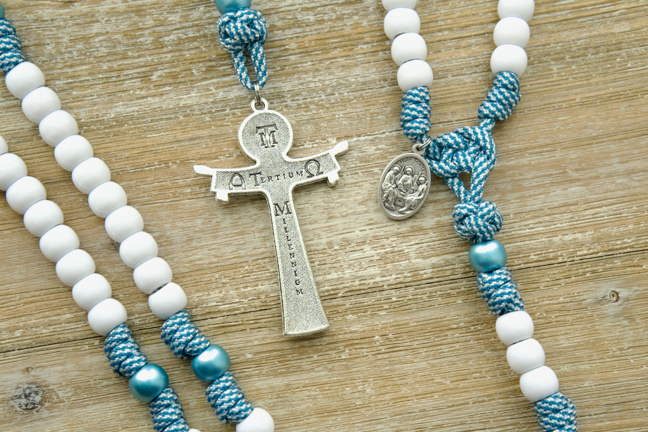 The Mater Boni Consilii (Our Lady of Good Counsel) - Teal Blue and White - 5 Decade Paracord Rosary, a durable and elegant Catholic gift featuring a large Holy Trinity crucifix and a unique devotional medal honoring Our Lady of Good Counsel. Perfect for priests and devout Catholics seeking spiritual guidance in their daily lives.