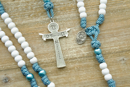 The Mater Boni Consilii (Our Lady of Good Counsel) - Teal Blue and White - 5 Decade Paracord Rosary, a durable and elegant Catholic gift featuring a large Holy Trinity crucifix and a unique devotional medal honoring Our Lady of Good Counsel. Perfect for priests and devout Catholics seeking spiritual guidance in their daily lives.