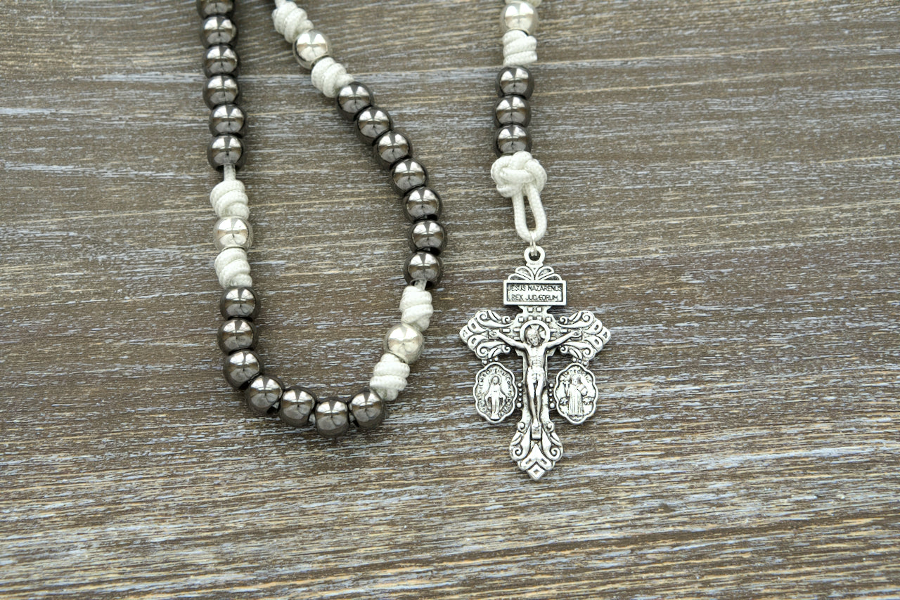 The 7 Sorrows Servite Rosary - Mater Dolorosa - White, Silver, Gunmetal. Premium, unbreakable paracord rosary chaplet featuring a 2" Pardon Crucifix. Catholic gift designed for contemplation and spiritual growth with silver Our Father beads, gunmetal Hail Mary beads, and the Mater Dolorosa/Ecce Homo centerpiece.