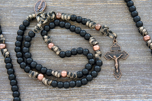 Mini Duty Hail Mary rosary in camo black and brown paracord with 10mm matte black and antique copper beads, finished with a copper Pardon crucifix and miraculous medal.