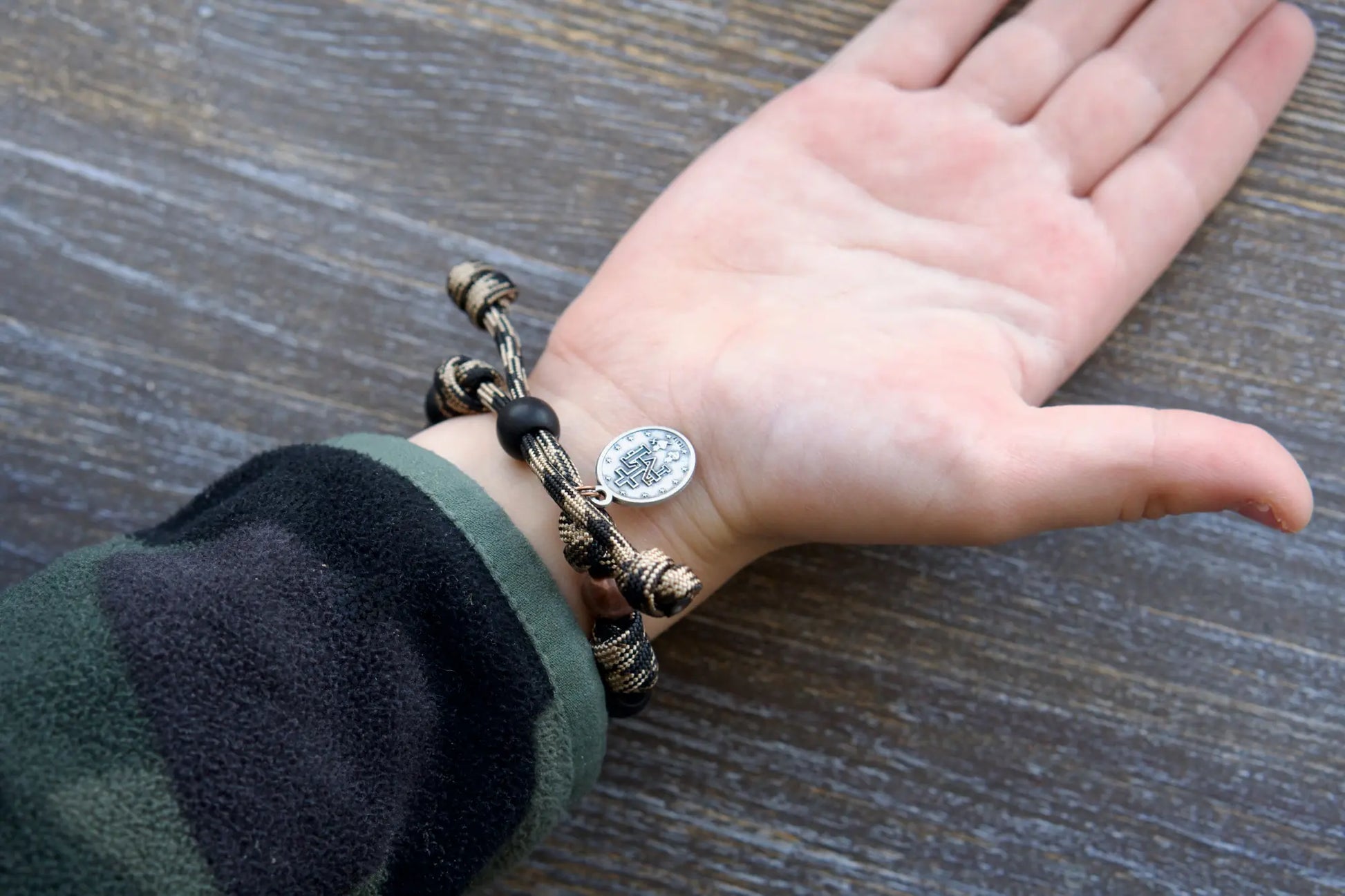 This Mini Duty Hail Mary kids' rosary bracelet features rugged 10mm matte black beads, an antique copper Our Father bead, and a sacred Miraculous Medal.