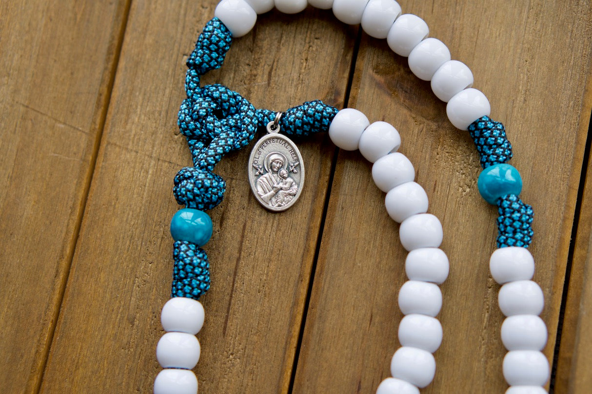 Our Lady of Perpetual Help - Turquoise - 5 Decade Paracord Rosary: A powerful, unbreakable Catholic gift featuring Our Lady of Perpetual Help design with white Hail Mary beads, matching turquoise Our Father beads, and a large 3" white enamel St. Benedict Crucifix.
