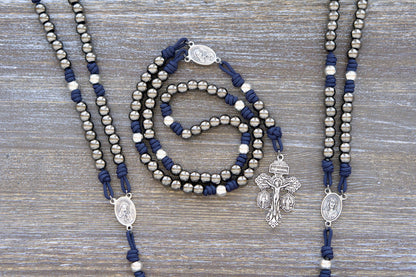 A handcrafted Navy Blue Servite Rosary chaplet, featuring 10mm metal alloy Hail Mary and Our Father beads, a Mater Dolorosa/Ecce Homo centerpiece medal, and a sturdy silver triple crucifix.