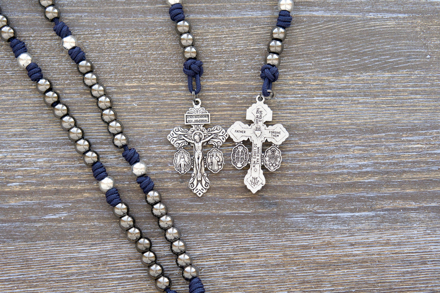 Navy blue paracord Servite rosary chaplet with gunmetal Hail Mary beads, silver Our Father beads, and a Mater Dolorosa/Ecce Homo centerpiece medal. Handmade by Sanctus Servo featuring a sturdy triple-threat pardon crucifix.