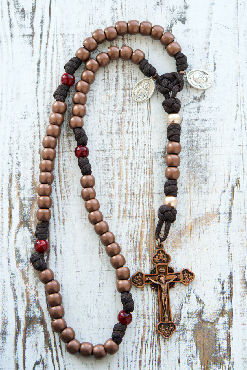 St. Padre Pio's Intercession - 5 Decade Paracord Rosary in Brown, Red, and Antique Copper with Stigmata-inspired beads and Sacred Heart of Jesus medal. Premium unbreakable paracord rosary for deepening faith and Catholic gifts.