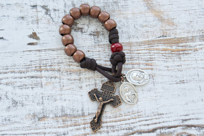 St. Padre Pio's Intercession - 1 Decade Paracord Rosary with antique copper Hail Mary beads, maroon red Our Father bead honoring Stigmata wounds, Sacred Heart of Jesus and St. Padre Pio devotional medals, and a standard size copper Pardon Crucifix. Premium durable paracord rosary for deepening faith and Catholic gifts.