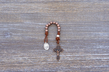 St. Padre Pio Premium Metal Paracord Rosary with copper Hail Mary beads, silver Our Father bead, and copper pardon crucifix.