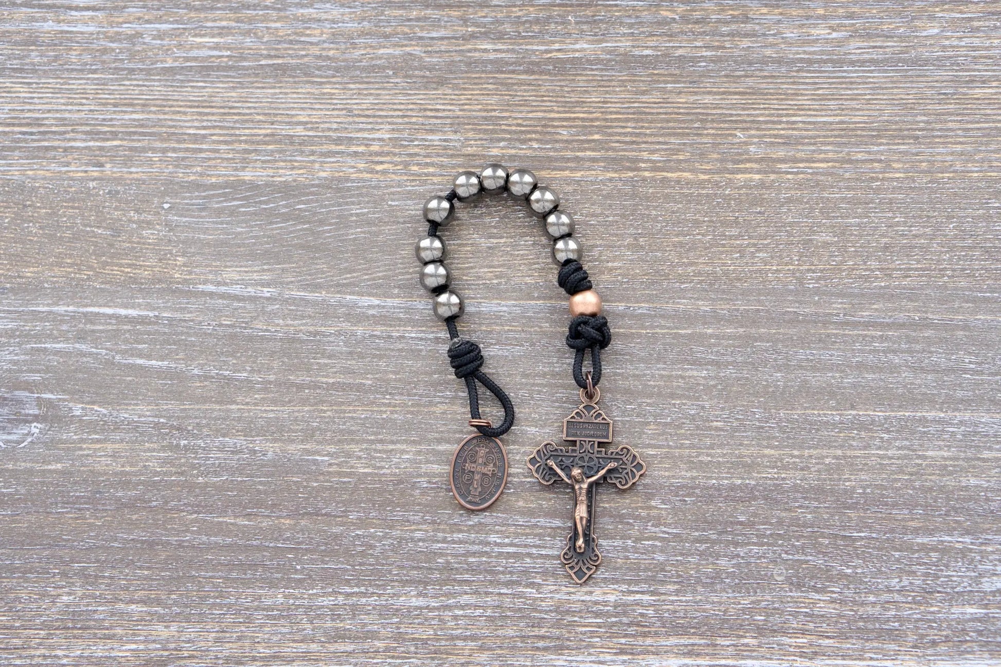 Premium metal paracord rosary with copper crucifix and St. Benedict medal, designed for spiritual wear and everyday use