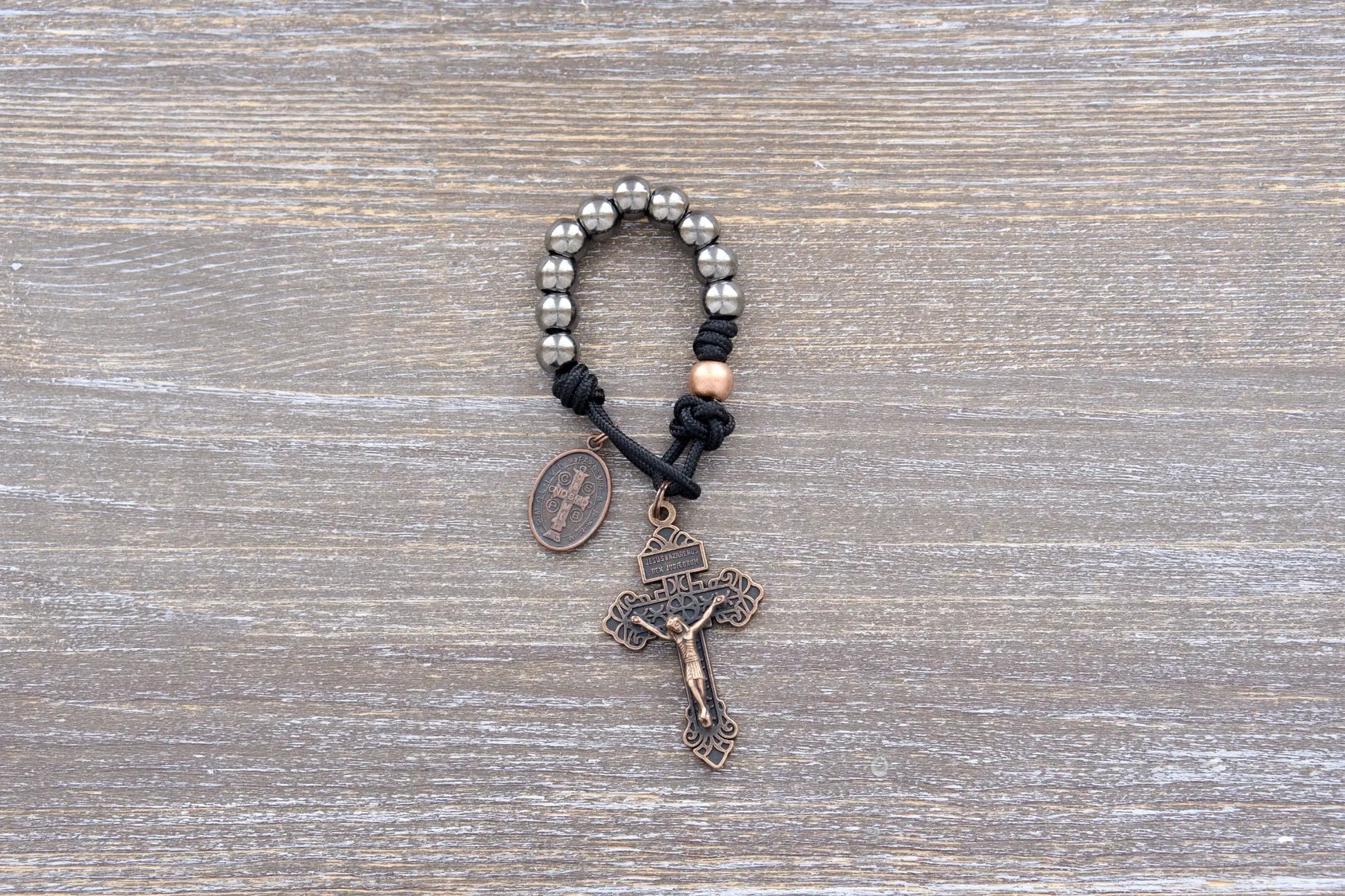 Premium metal paracord rosary with copper crucifix and St. Benedict medal, featuring durable alloy beads and a timeless spiritual design