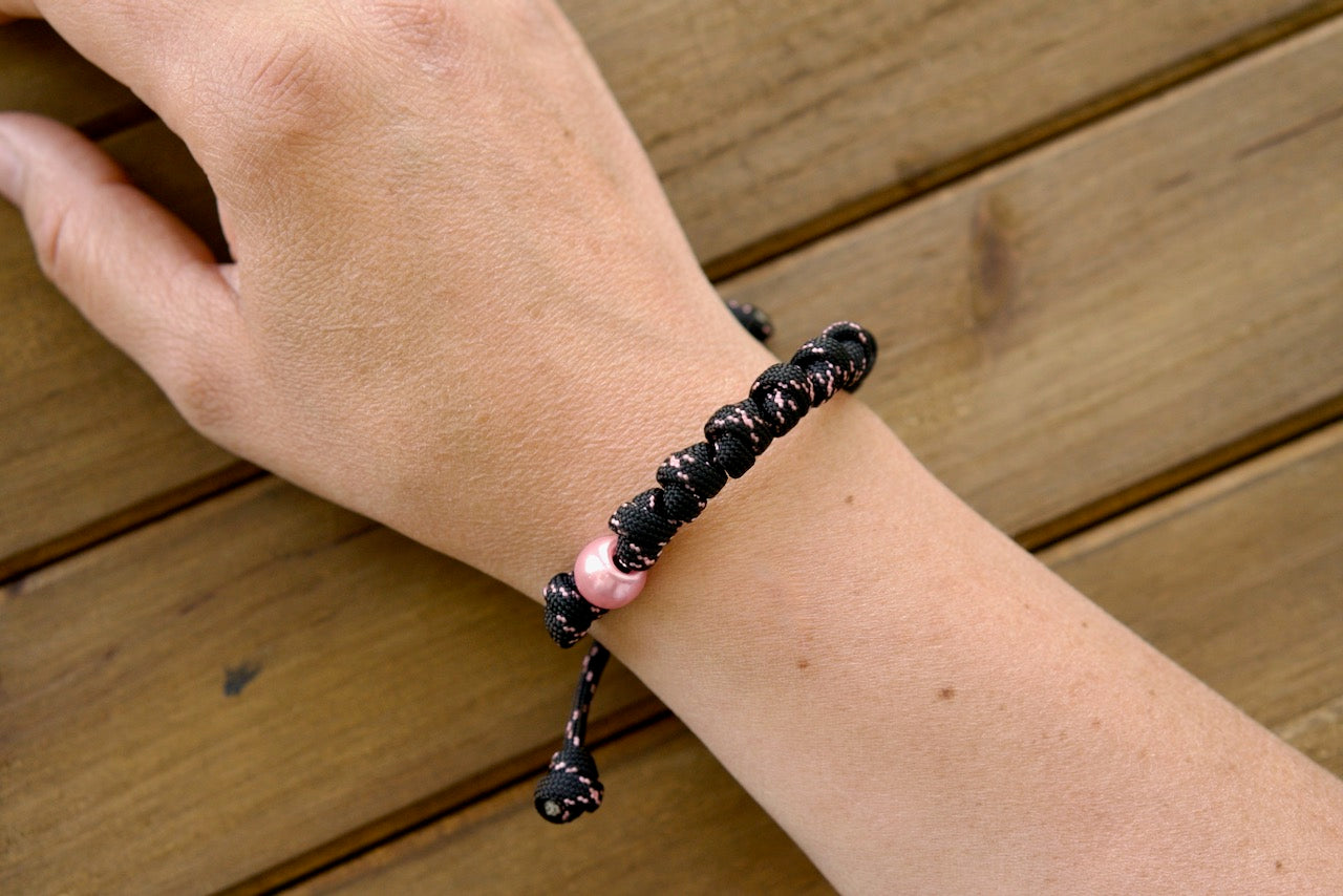 Pink and Black Rosary Bracelet - Handcrafted, Durable Paracord Catholic Accessory with Stylish Pink Bead, Perfect for Daily Prayer and Inspiring Faith.