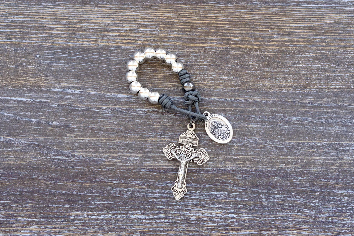Protector of Holy Church Pocket Paracord Rosary - featuring gray paracord rope, silver metal alloy beads, pardon crucifix and St. Joseph medal.