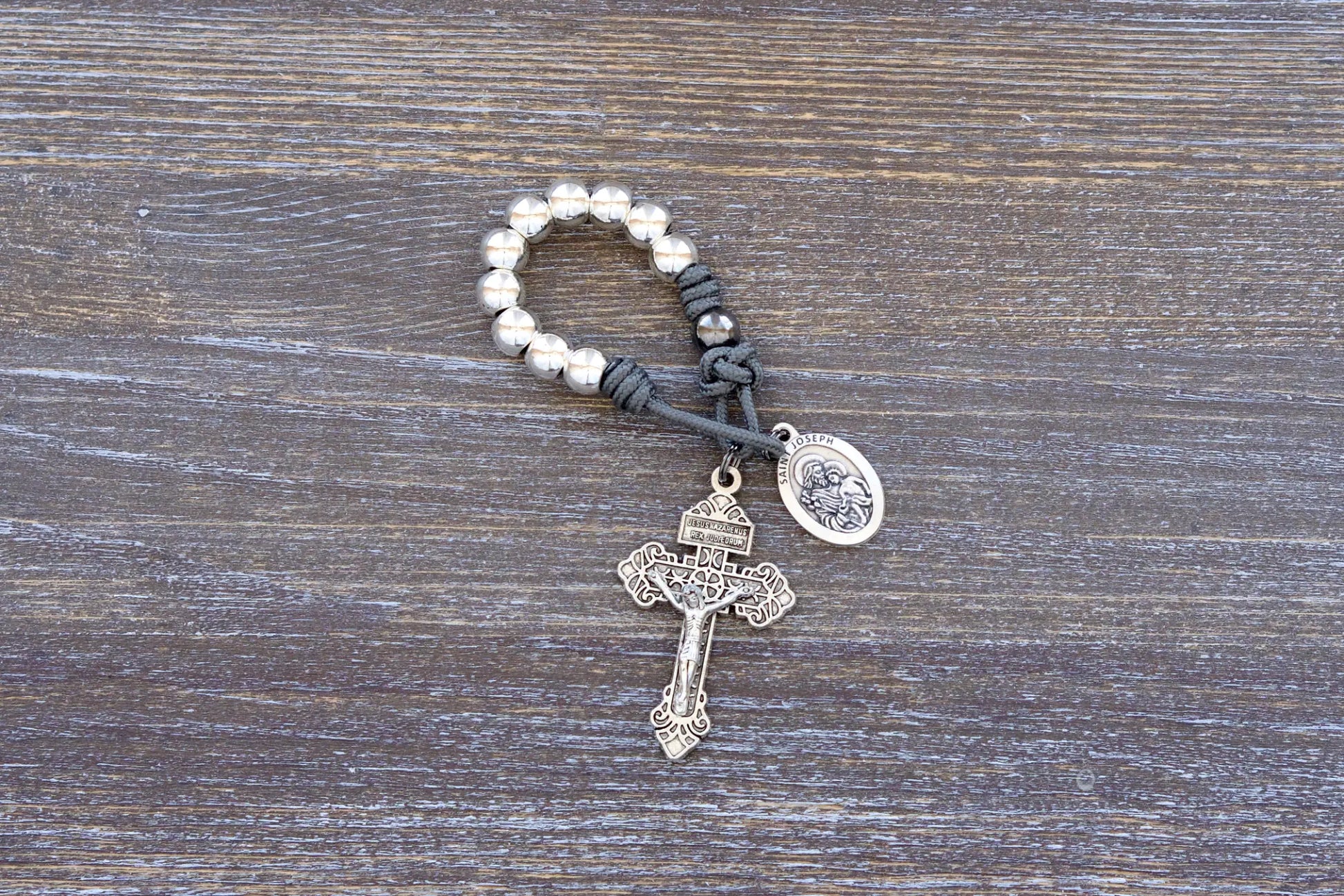 Protector of Holy Church Pocket Paracord Rosary - featuring gray paracord rope, silver metal alloy beads, pardon crucifix and St. Joseph medal.