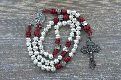 Bold gunmetal rosary with Crimson Red paracord, Hail Mary and Our Father beads, and engraved St. Michael pendant.