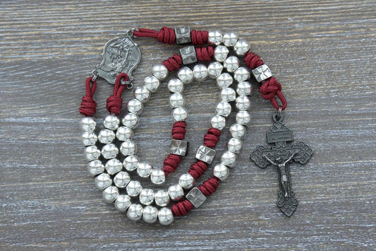 Bold gunmetal rosary with Crimson Red paracord, Hail Mary and Our Father beads, and engraved St. Michael pendant.