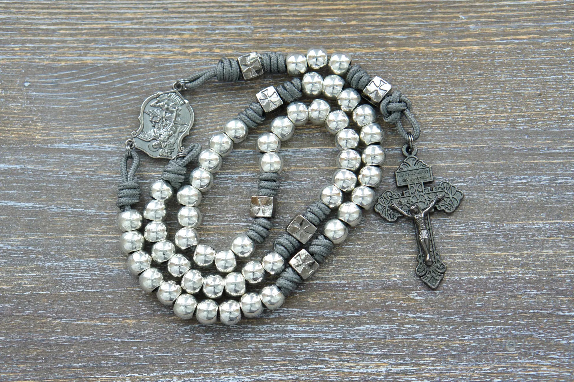 Bold gunmetal "Reclaim Christendom" paracord rosary with iron gray rope, silver metal Hail Mary Beads and navy gunmetal crucifix and centerpiece.